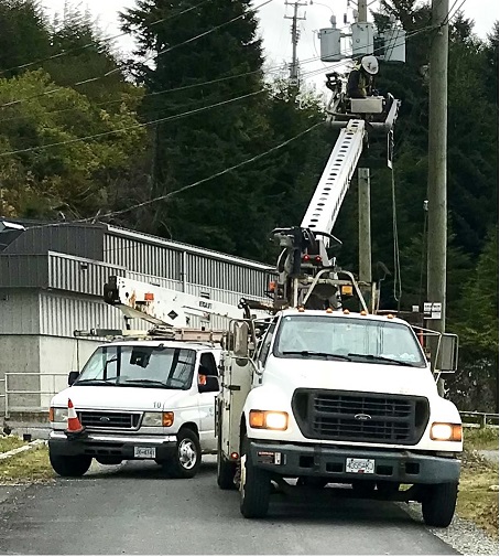 Pacific West Cable bucket trucks at work on an aerial cable installation